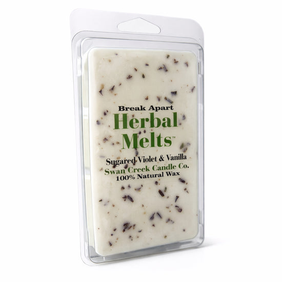 Herbal Melts wax bar with visible ingredients in a clear packaging on a white background